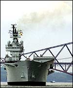 HMS Ark Royal as it leaves Rosyth under the Forth bridge in Fife, Scotland 