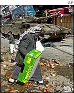 Vendor retrieves goods after bulldozers sweep through market 