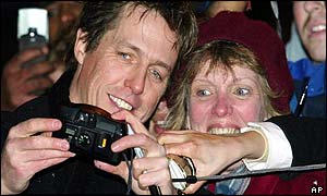 Hugh Grant with a fan