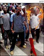 Protesters burning the French flag