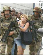 Troops escort a French national