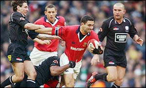 Munster's full-back Jeremy Staunton is tackled by Neath's Alfie Mocelutu