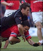 Neath's James Storey tackles Jeremy Staunton of Munster