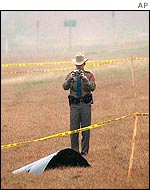 Texas policeman photographs a piece of shuttle debris