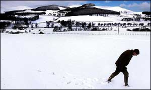 Man in a snowy field in the Borders 