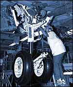 Work on one of Columbia's wheel wells 