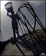 A Palestinian girl atop her family's house, demolished by Israeli soldiers