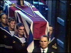 Godfrey Dykes (C) leads the bearers into the Abbey