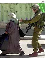 Israeli soldier and Palestinian woman