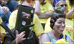Two fans dressed as famous Australian bushranger Ned Kelly (L) and the Queen of England (R)