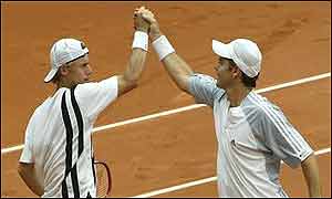 Lleyton Hewitt and Todd Woodbridge of Australia celebrate after defeating Miles Maclagan and Arvind Parmar 