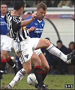 Jason Dair challenges Rangers' Arthur Numan