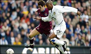 Duberry battles with Joe Cole as he replaces the injured Lucas Radebe in defence