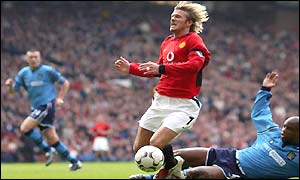 David Beckham goes down under a challenge from David Sommeil