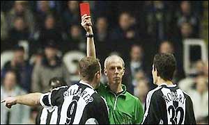 Robert is sent off after illegally blocking a Dennis Bergkamp free-kick 