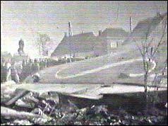 Wreckage showing Sabena logo on tailfin and houses behind 