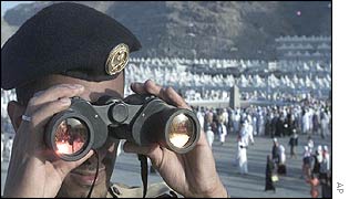 A Saudi Arabian policeman observes the area around the stoning site