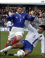 Nikola Lazetic of Serbia and Montenegro is tackled by Kemal Guliyev of Azerbaijan