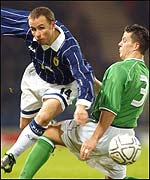 Paul Devlin is challenged by Ian Harte