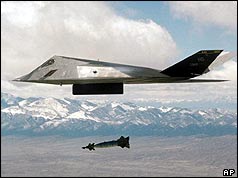 F-117 bomber flying over mountains