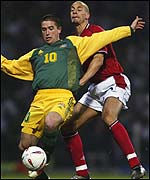 Australia's Harry Kewell (left) in action against Rio Ferdinand