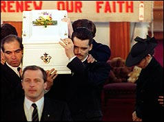 Ralph Bulger (r) helps carry his son's coffin