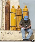 A UN inspector takes notes at a water purification plant