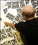 An anti-war activist prepares posters in London