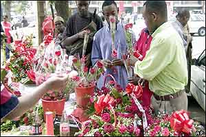 Kenyans line up to buy roses from a street vendor in the capital Nairobi