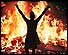 Music lover dances in front of a blazing bonfire at Woodstock 99