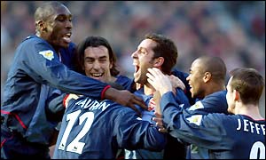 Arsenal players celebrate after Edu's goal gives them a 1-0 lead going into half-time