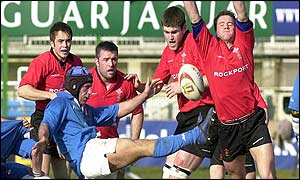 Mark Jones charges down a kick by Italy's Alessandro Troncon 