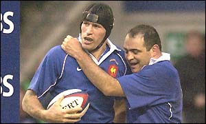 Olivier Magne is congratulated on scoring France's try