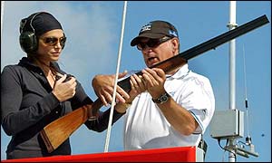Cindy Crawford and a race official prepare to start the first race of the America's Cup
