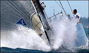 The crew of the Swiss yacht, Alinghi, head towards the finish and victory in the first race