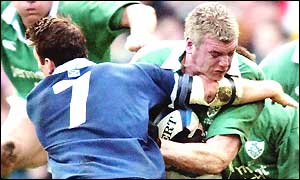 Scottish number seven Andrew Mower tries to tackle Irish flanker Victor Costello,