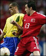 Muzzy Izzet (right) rubs shoulders with Rivaldo of Brazil in the World Cup semi-final