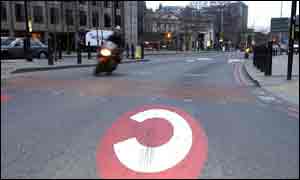 A motorcyclist drives through the central charging zone