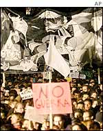 Protesters in front of a replica of a Picasso anti-war painting in Barcelona