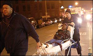 Emergency personnel carry a victim from the Epitome nightclub in Chicago early Monday morning