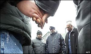 Community members pray outside the Epitome night club 
