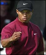 Woods pumps his fist to celebrate another birdie at the Buick