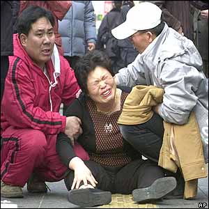 A victim's relative sobs