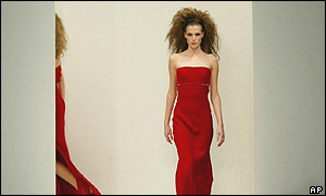 A model wears a scarlet evening dress by British-based designer Ben di Lisi 