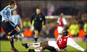 Ajax's Andy Van Der Meyde is challenged by Arsenal defender Sol Campbell