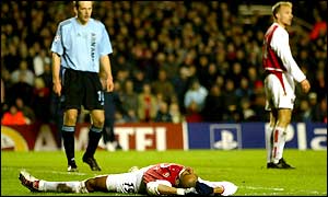 Gilberto lies on the floor in disbelief after seeing Arsenal team-mate Dennis Bergkamp miss a golden opportunity to take the lead