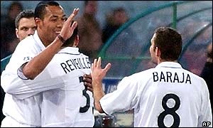 Valencia's Norwegian striker John Carew is congratulated by team-mates after scoring the winner at the Olimpico Stadium