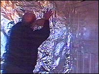 Alan Brookes puts foil up in his bedroom