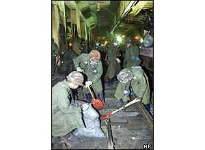 South Korean soldiers clean up the platform of the subway station 