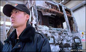 Policeman guards remains of subway train